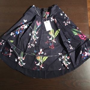 Plio Tropical Oasis Dip Hem Skirt